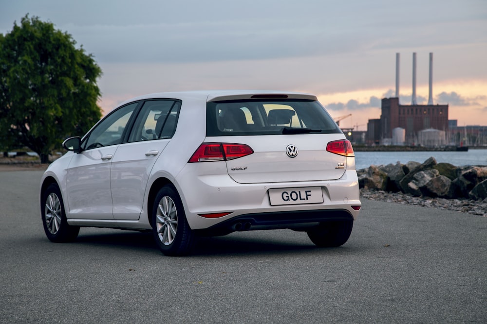 a white golf car parked on the side of the road