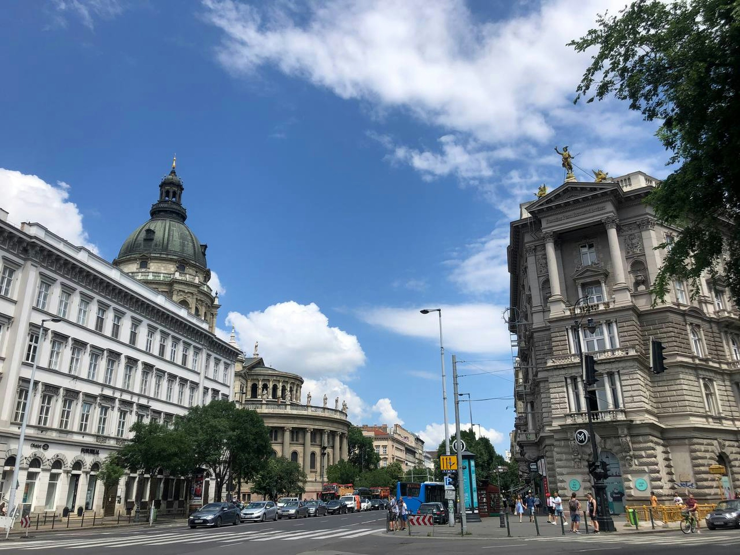 a city street filled with traffic next to tall buildings
