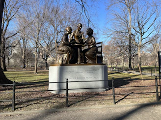 a statue of a group of people sitting on a bench
