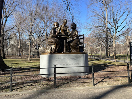a statue of a group of people sitting on a bench