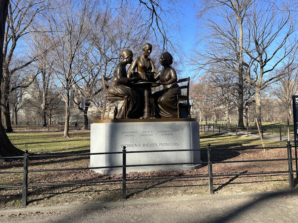 a statue of a group of people sitting on a bench