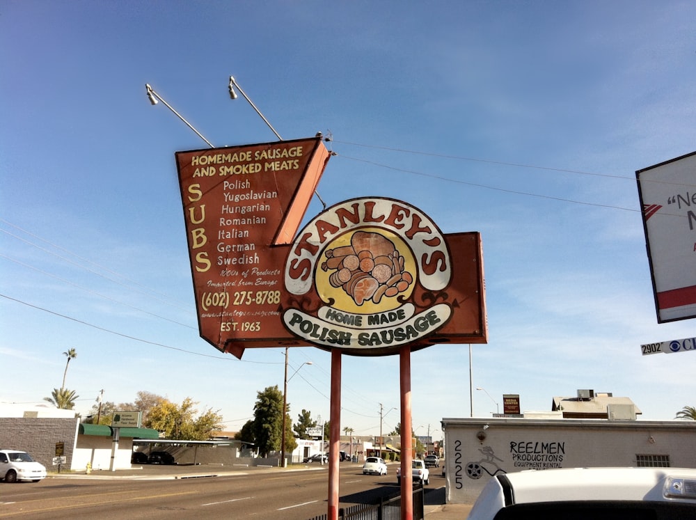 a sign for stanley's irish sausage on the side of the road