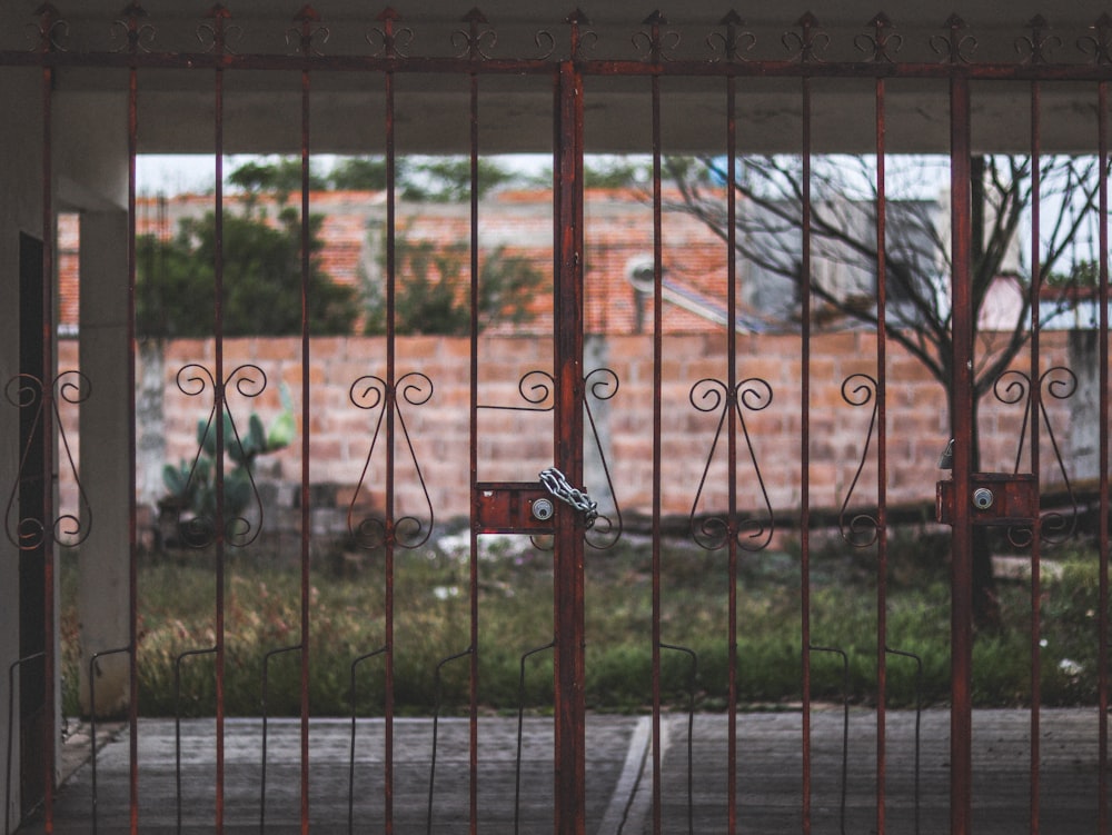 a gated area with a brick building in the background