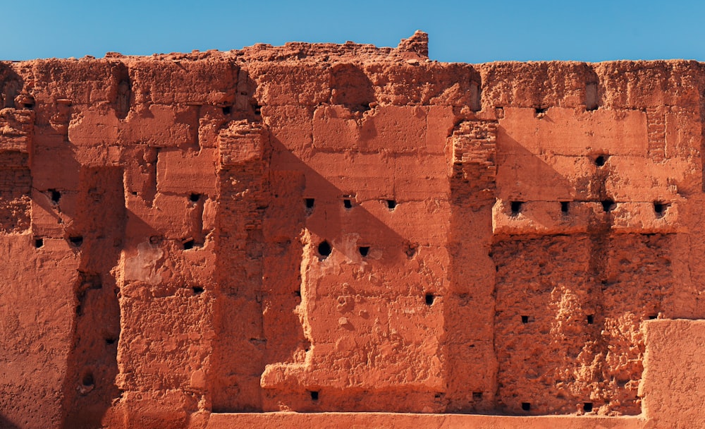 a red brick wall with holes in it