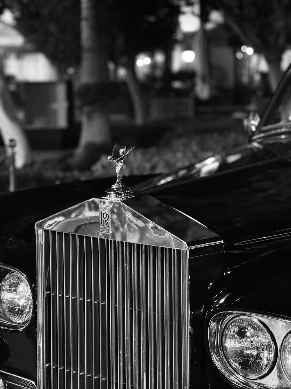 a black and white photo of a classic car