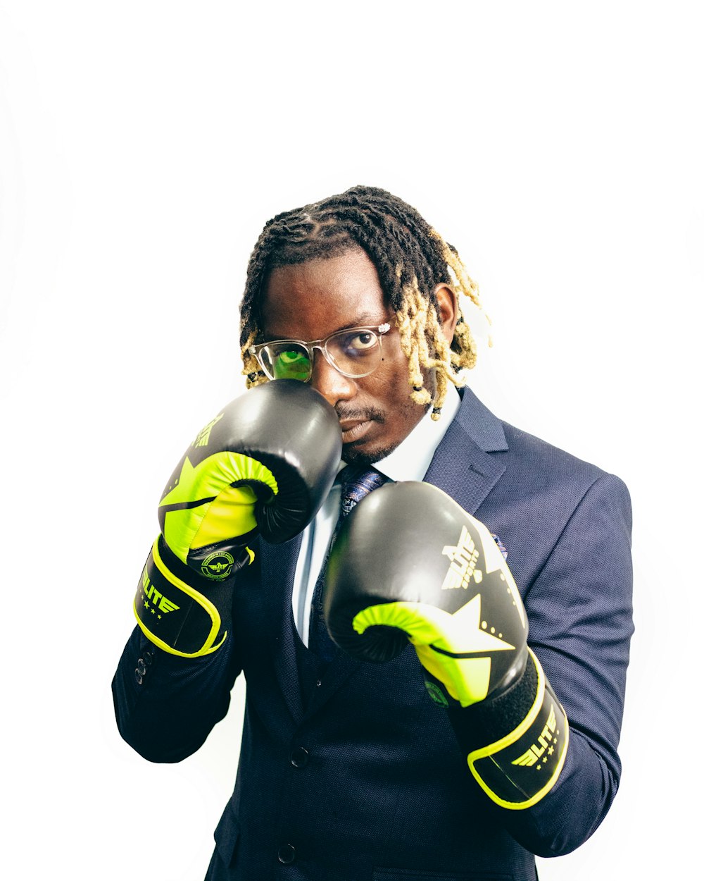 a man in a suit and tie wearing boxing gloves
