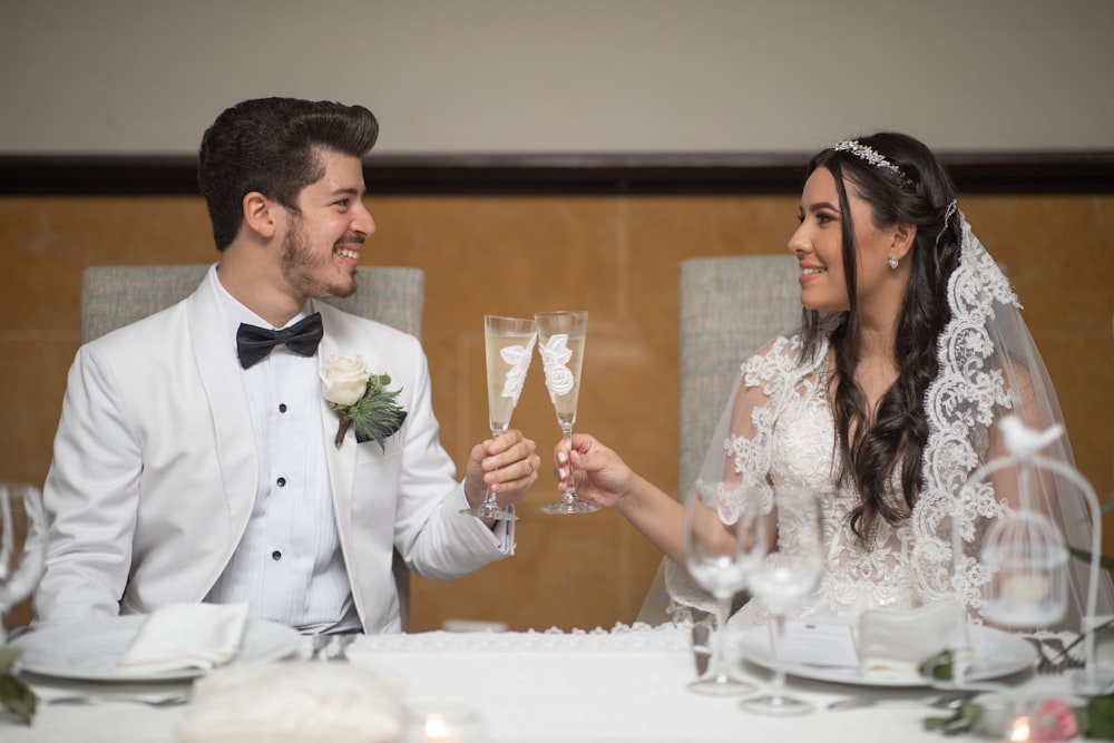 a bride and groom toasting with champagne glasses