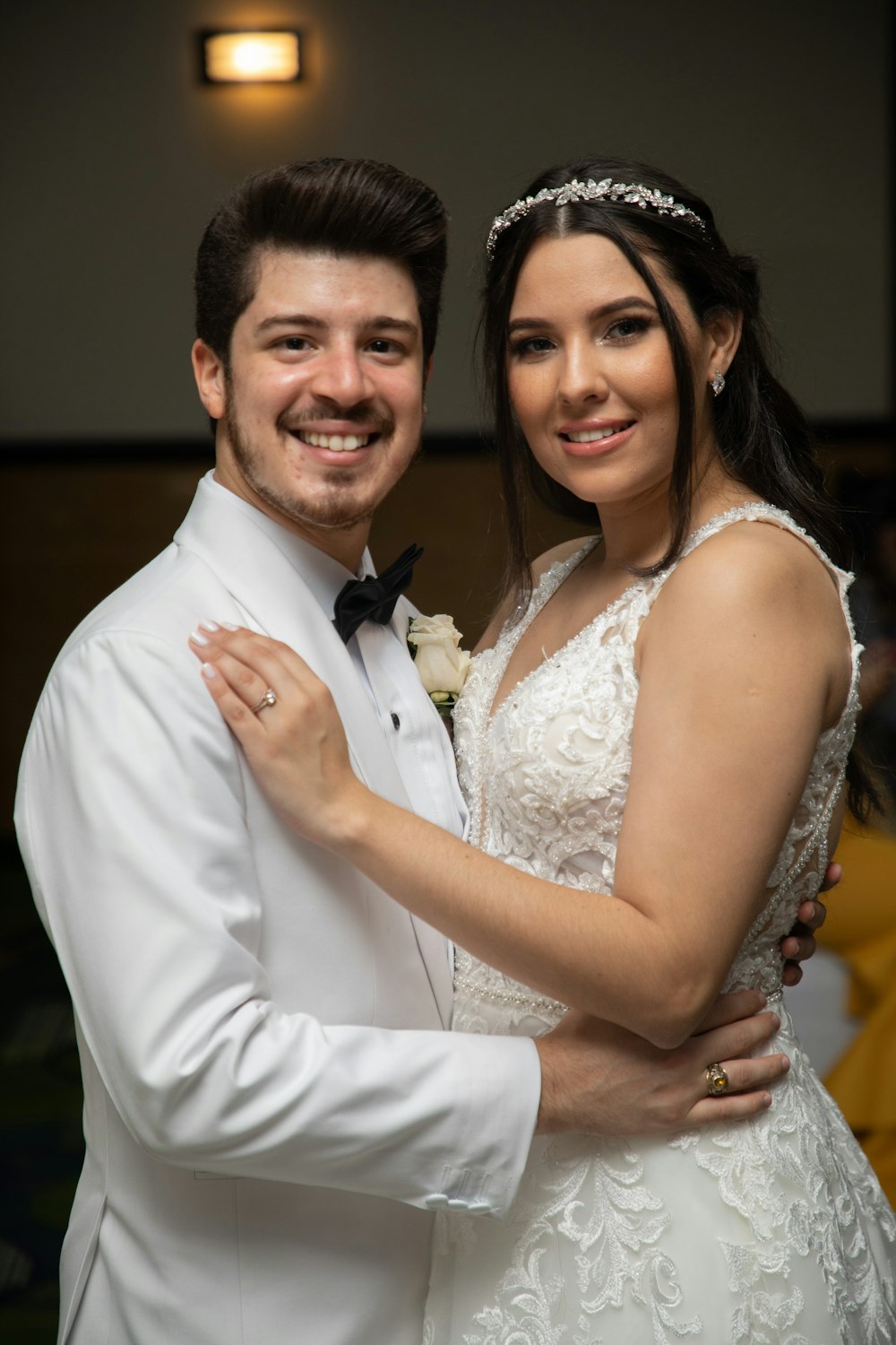 a bride and groom pose for a picture
