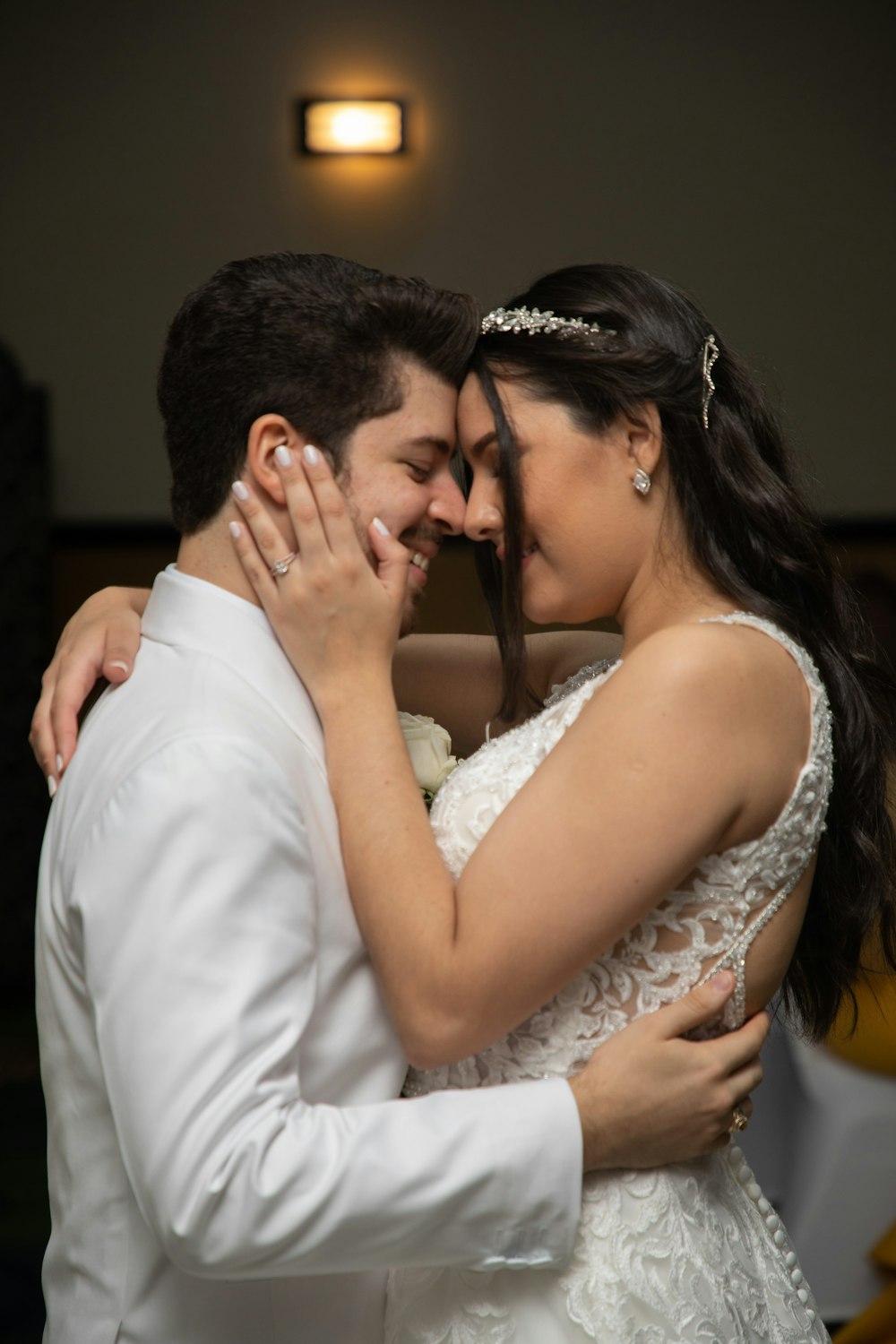 a bride and groom sharing a hug on their wedding day