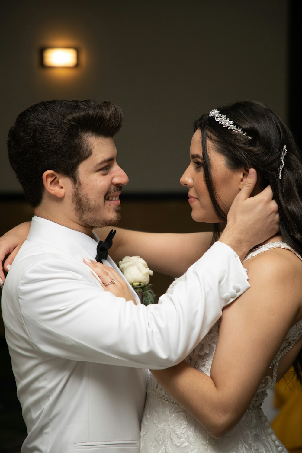 a bride and groom embracing each other at their wedding