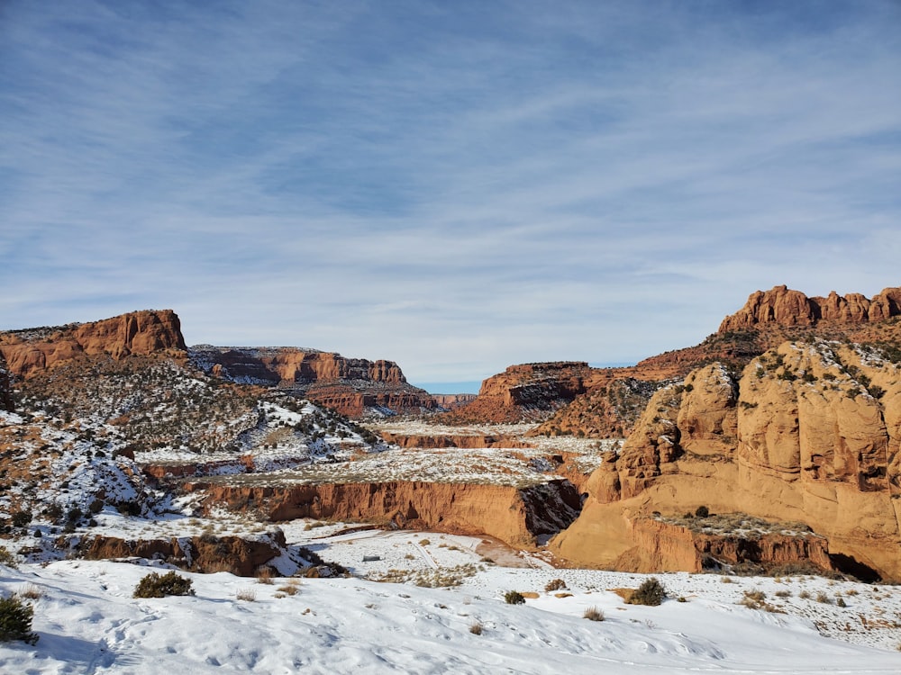 a snow covered landscape with mountains in the background