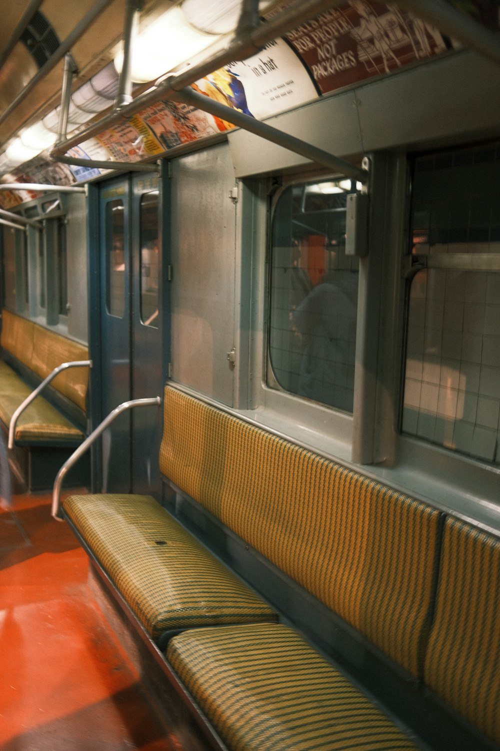 a subway car filled with lots of yellow seats