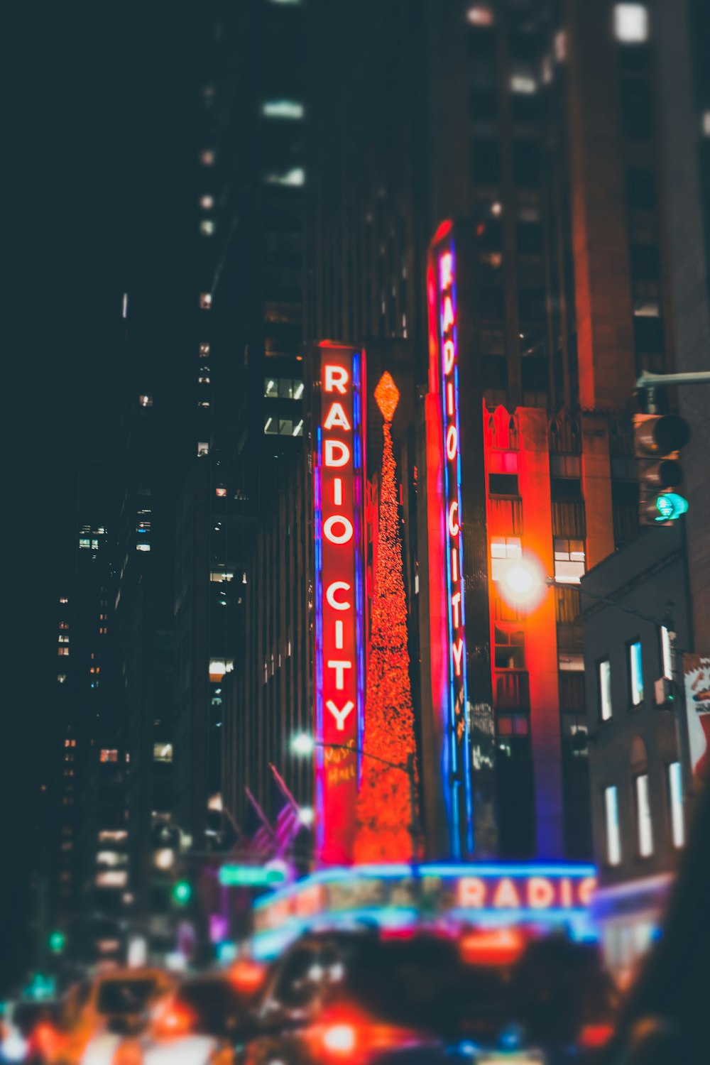 the radio city sign is lit up at night