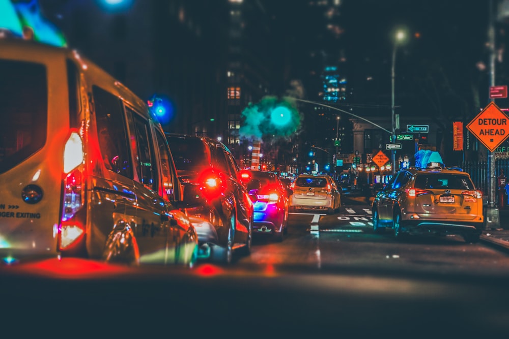 a city street filled with lots of traffic at night