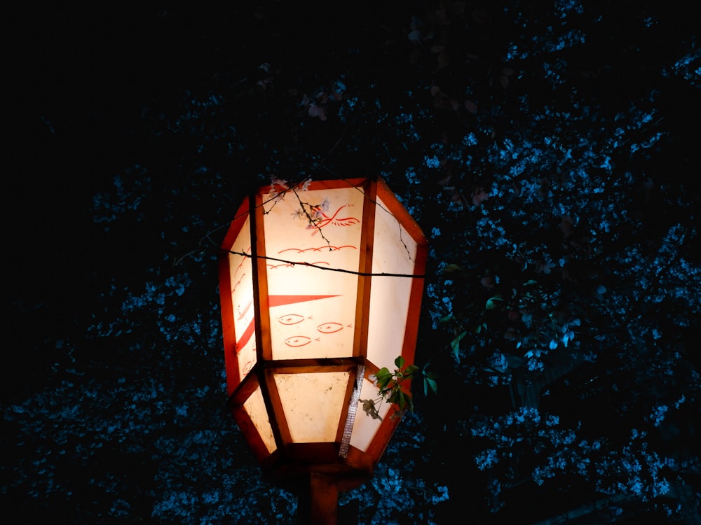 a lamp in the dark with a tree in the background