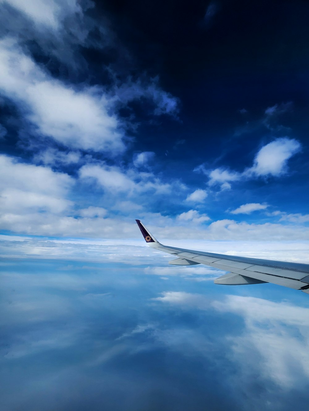 a view of the wing of an airplane in the sky