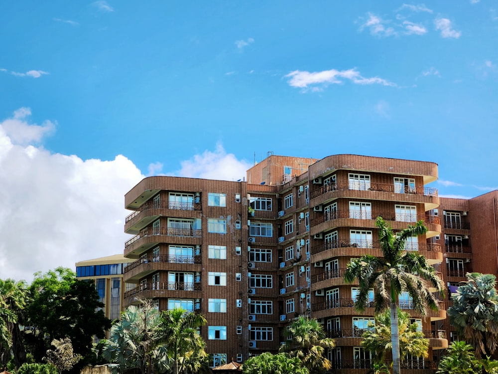 a tall building with lots of windows and palm trees