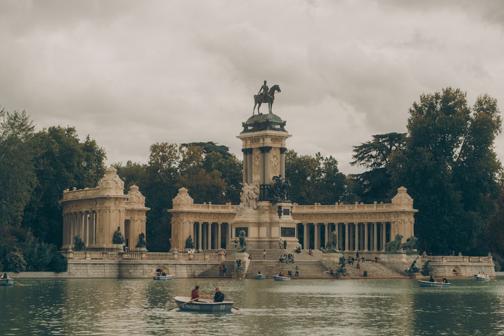 a boat is in the water near a statue