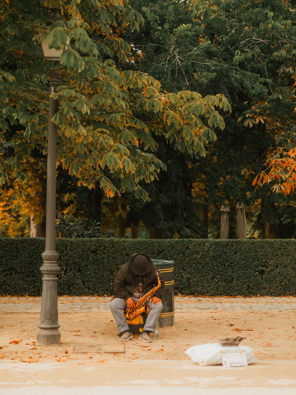 a man sitting on a bench playing a guitar