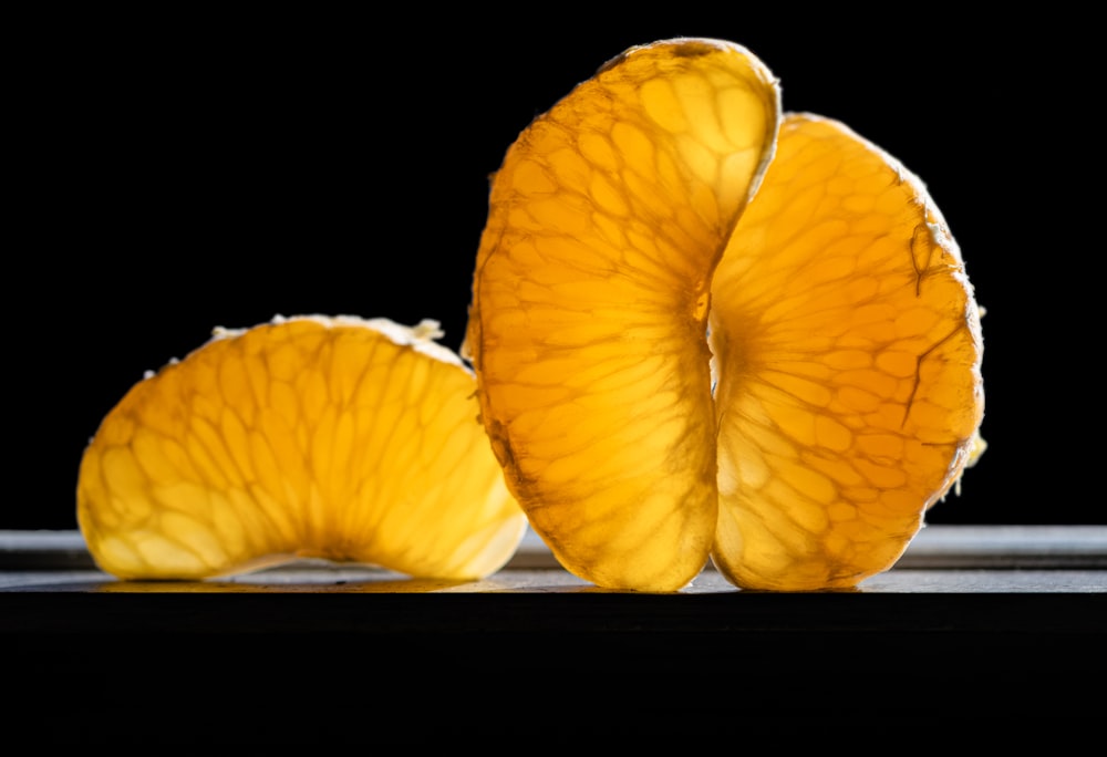 a couple of pieces of fruit sitting on top of a table