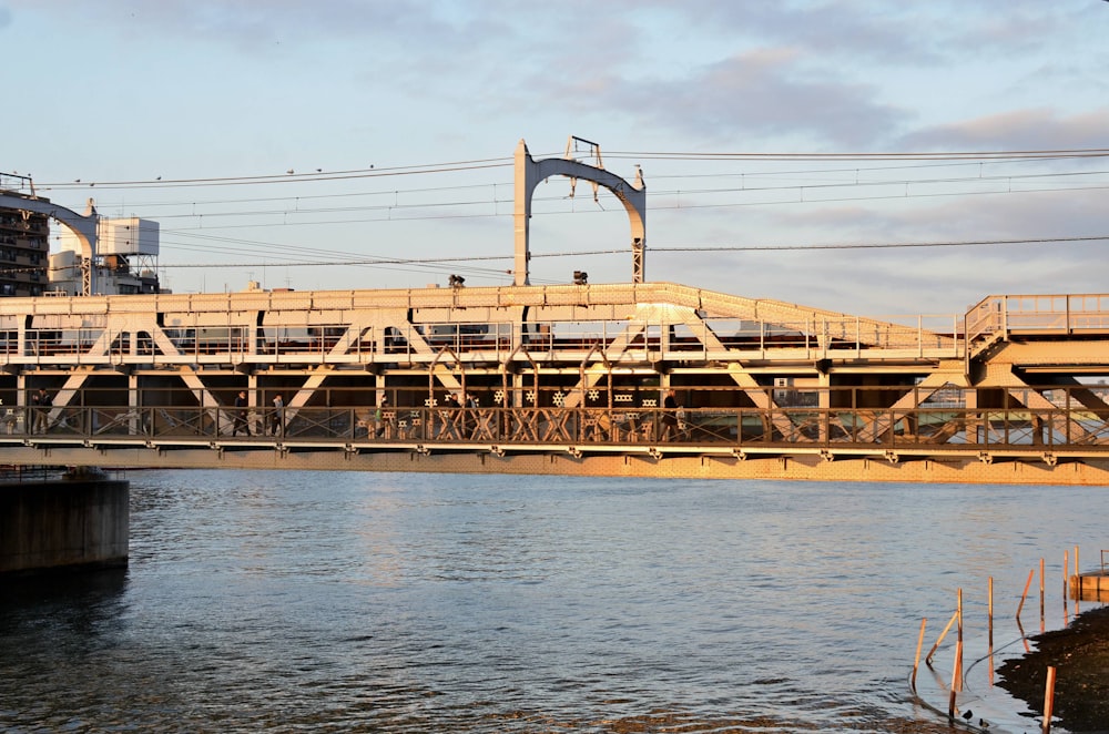 a bridge over a body of water with power lines above it