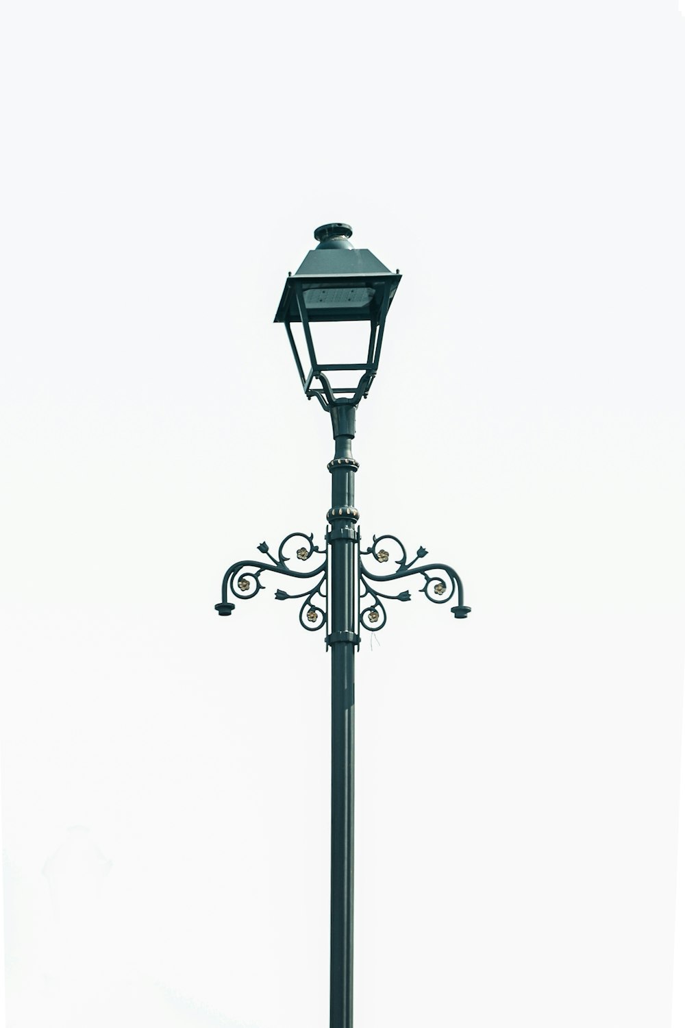 a black lamp post with a light on top of it
