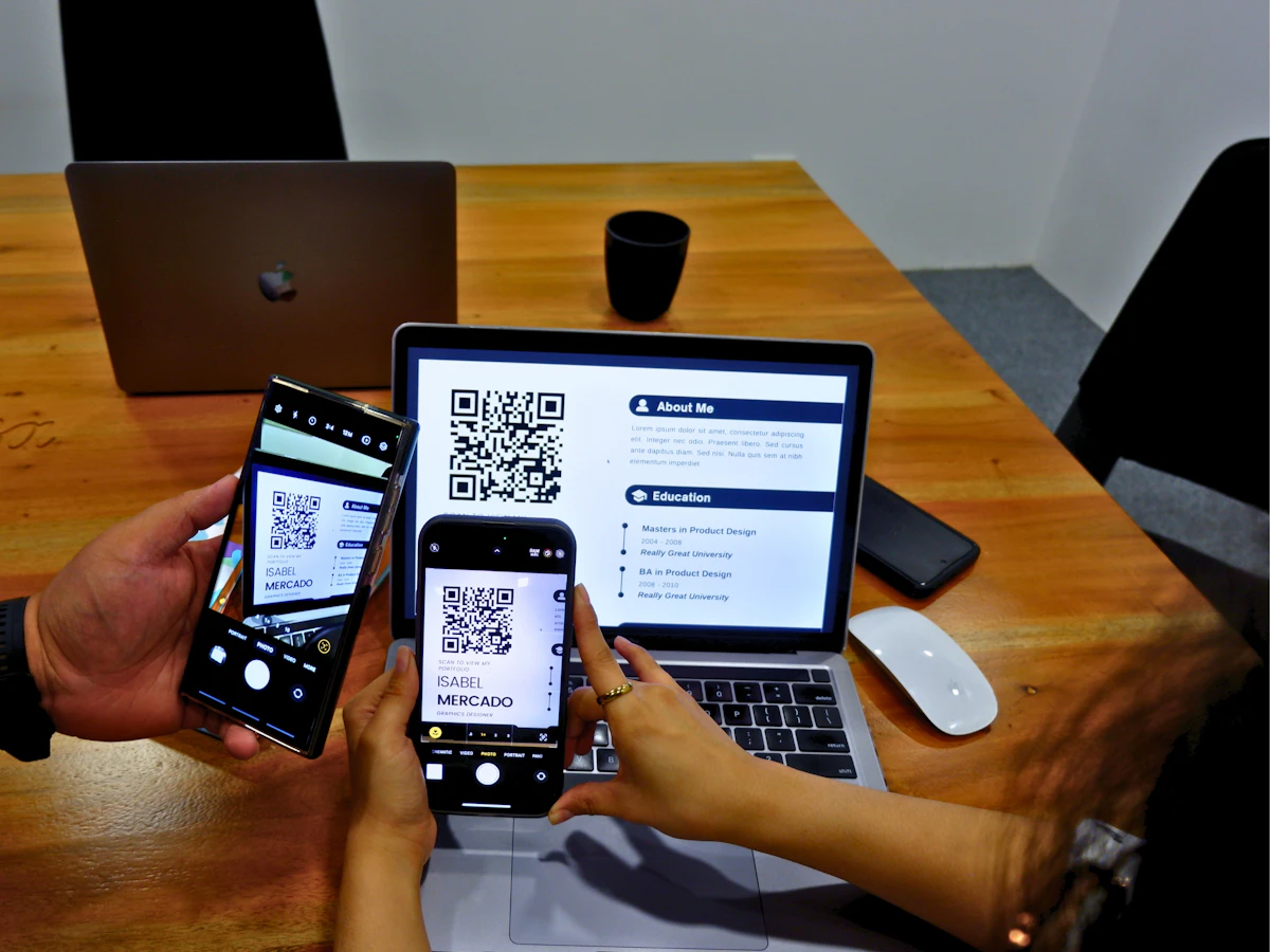 Two people at a table paying each other with their phones