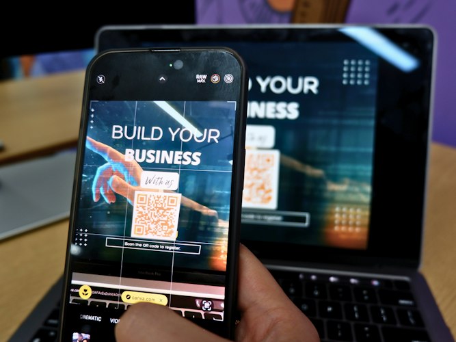 A smartphone showing a sales dashboard graph on a desk next to a coffee cup
