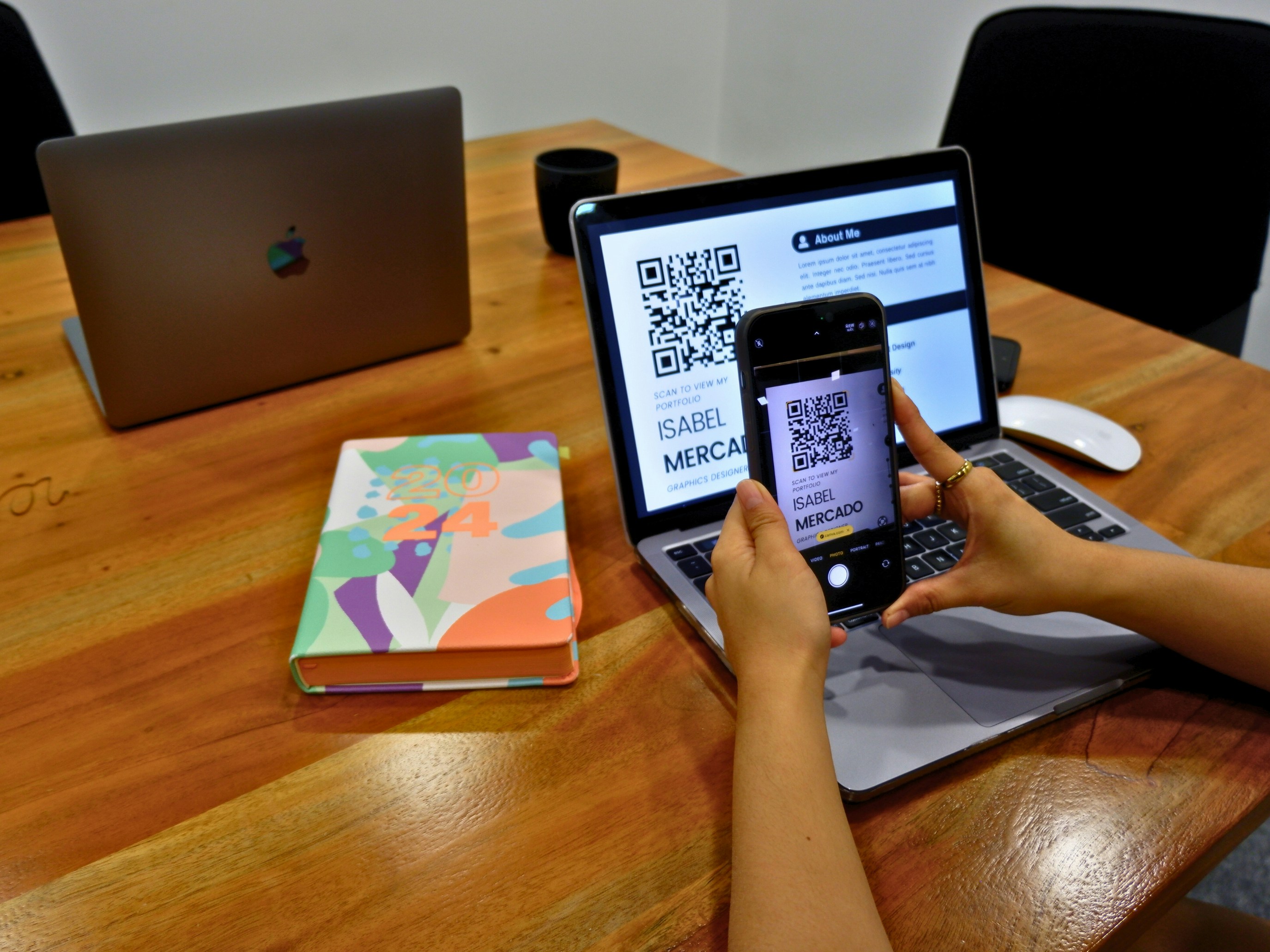 A person scanning a QR code on an applicant's resume to view their online portfolio.
