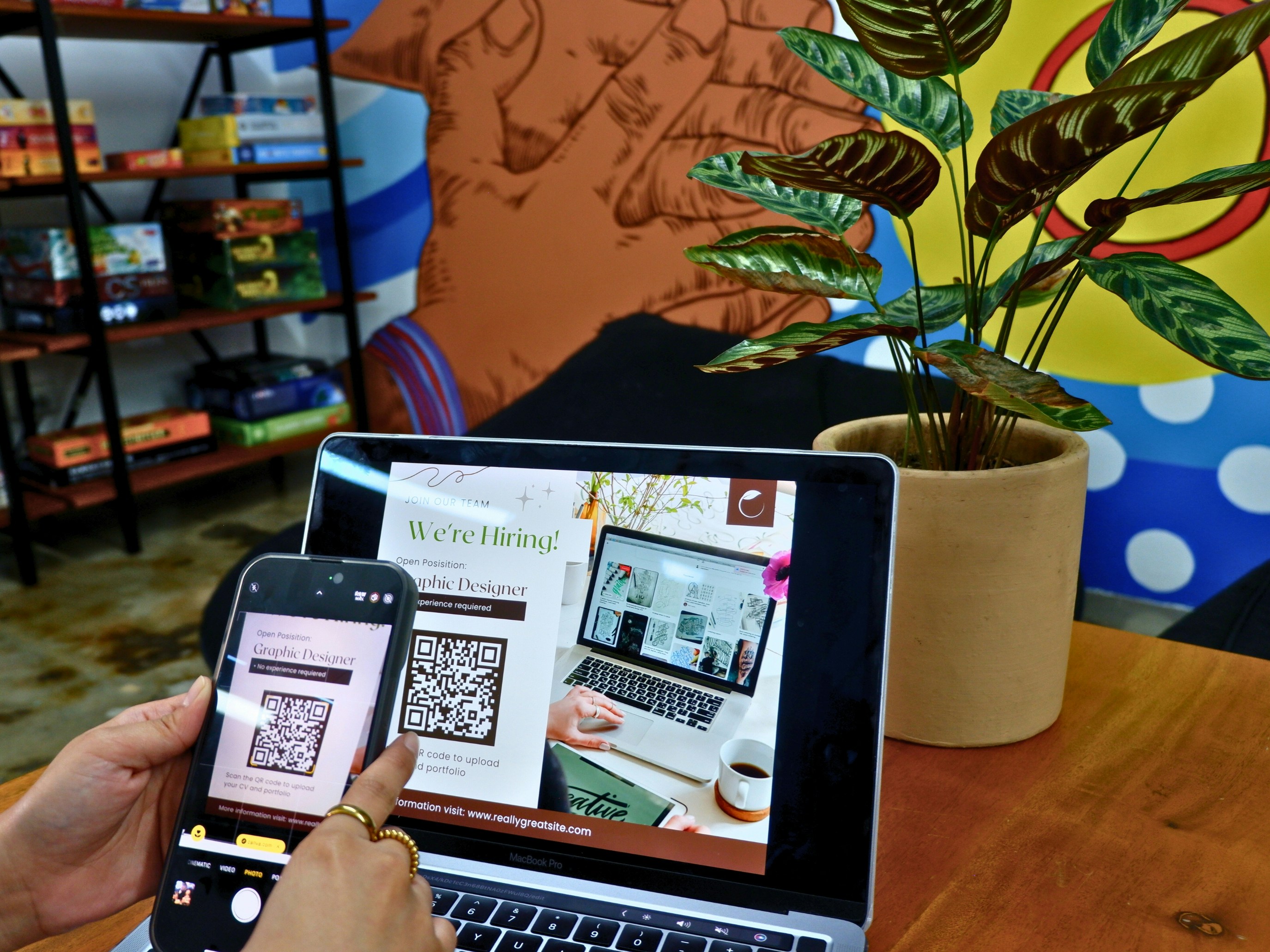 A person scanning a QR code to register and apply for a job position.