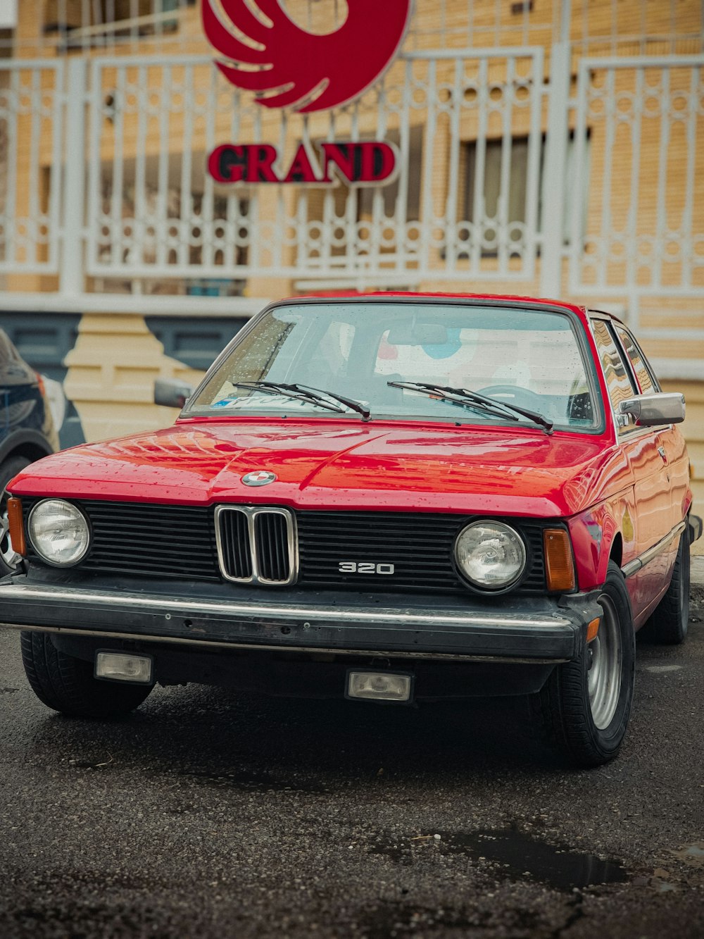 a red car parked in front of a building