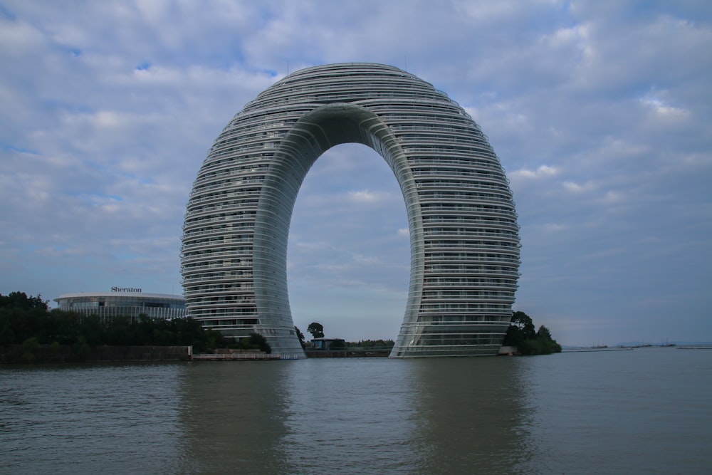 a very tall building sitting in the middle of a body of water