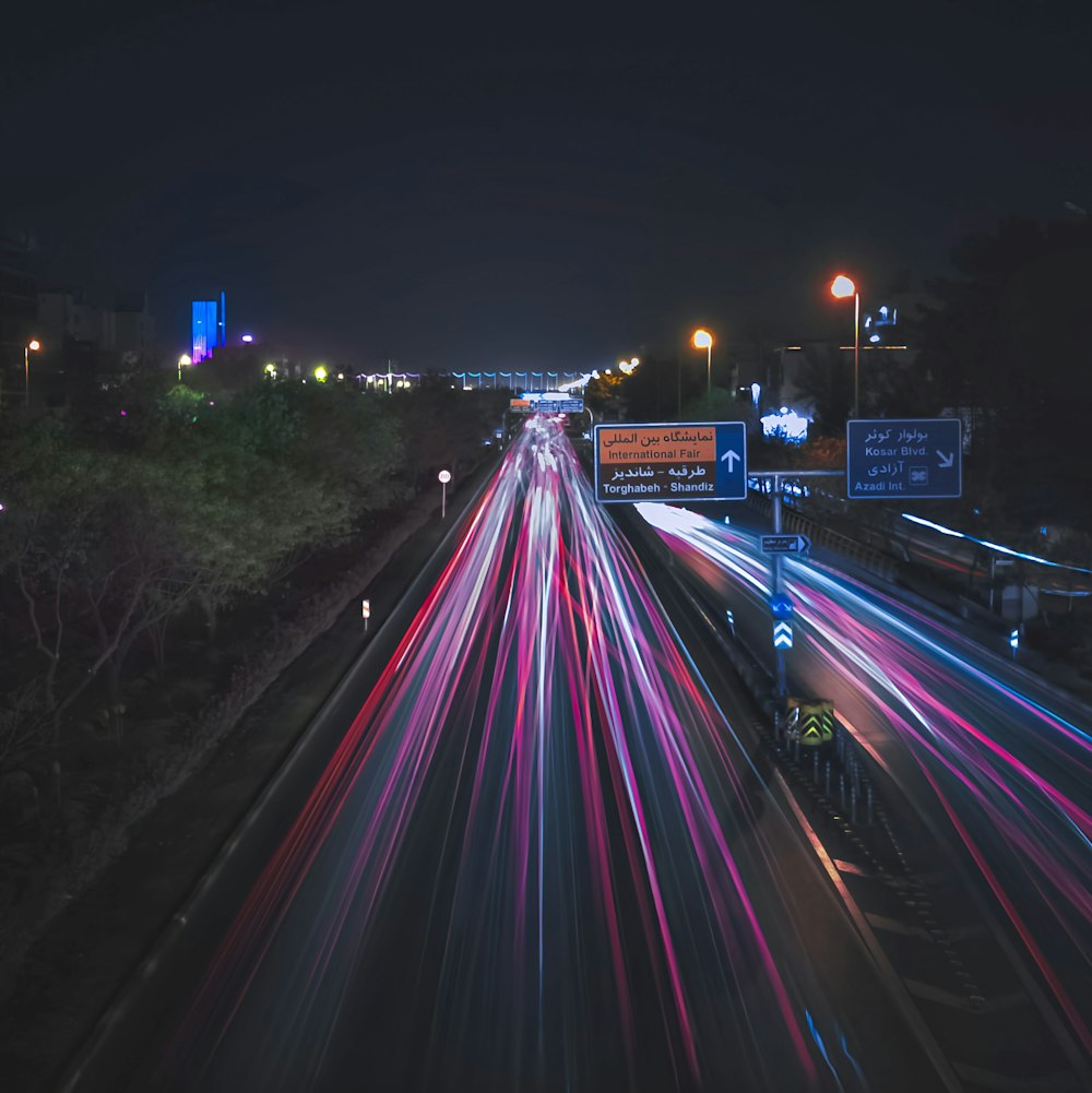 a long exposure photo of a highway at night