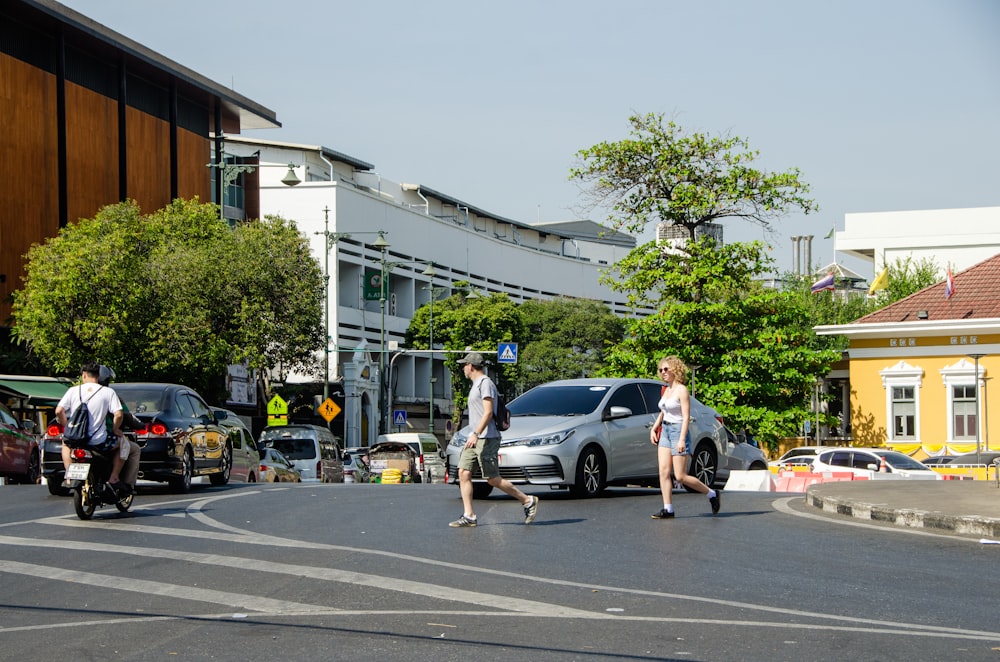 a group of people riding skateboards across a street