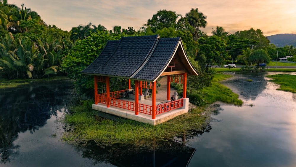 a small pavilion sitting on top of a lush green field