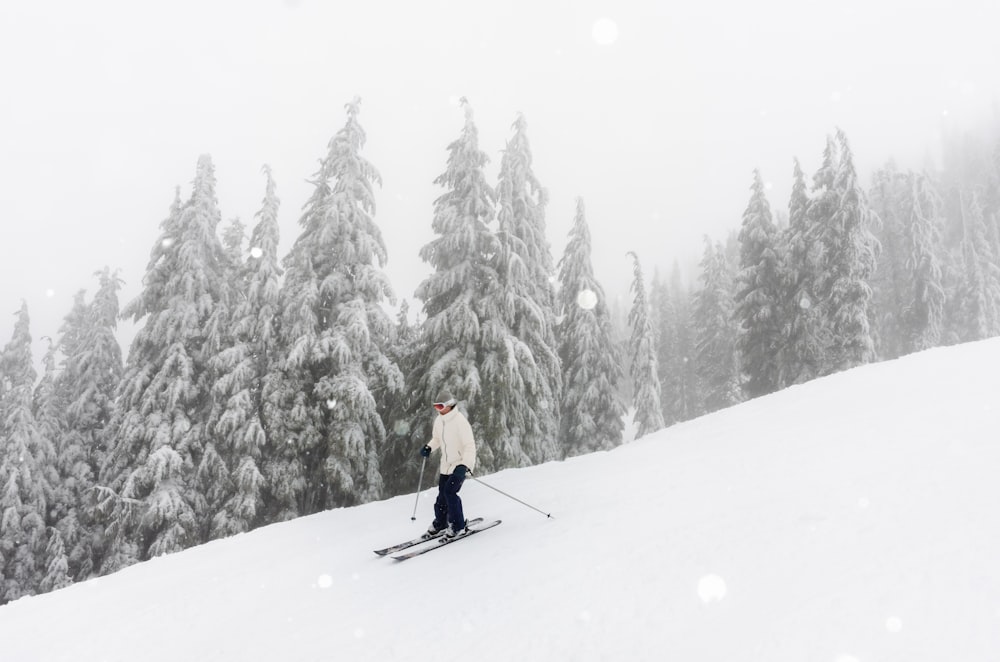 a person riding skis down a snow covered slope