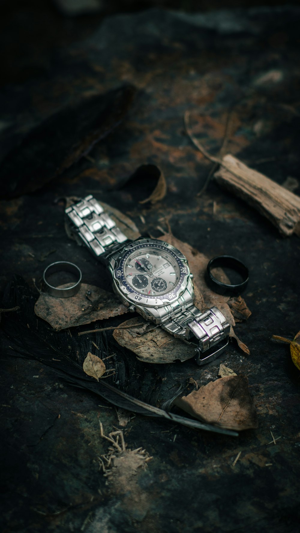 a watch sitting on top of a piece of wood