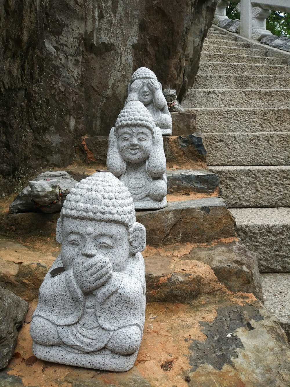 a couple of statues sitting on top of some rocks