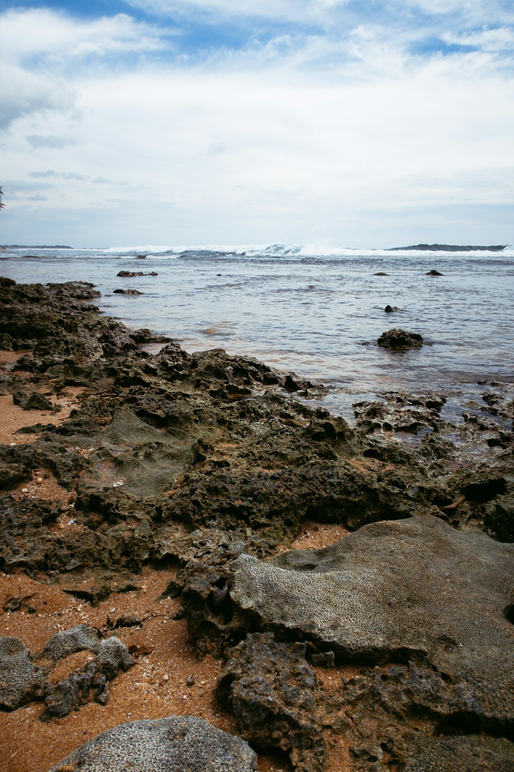 a view of the ocean from a rocky beach
