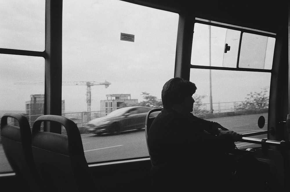 a person sitting on a bus looking out the window