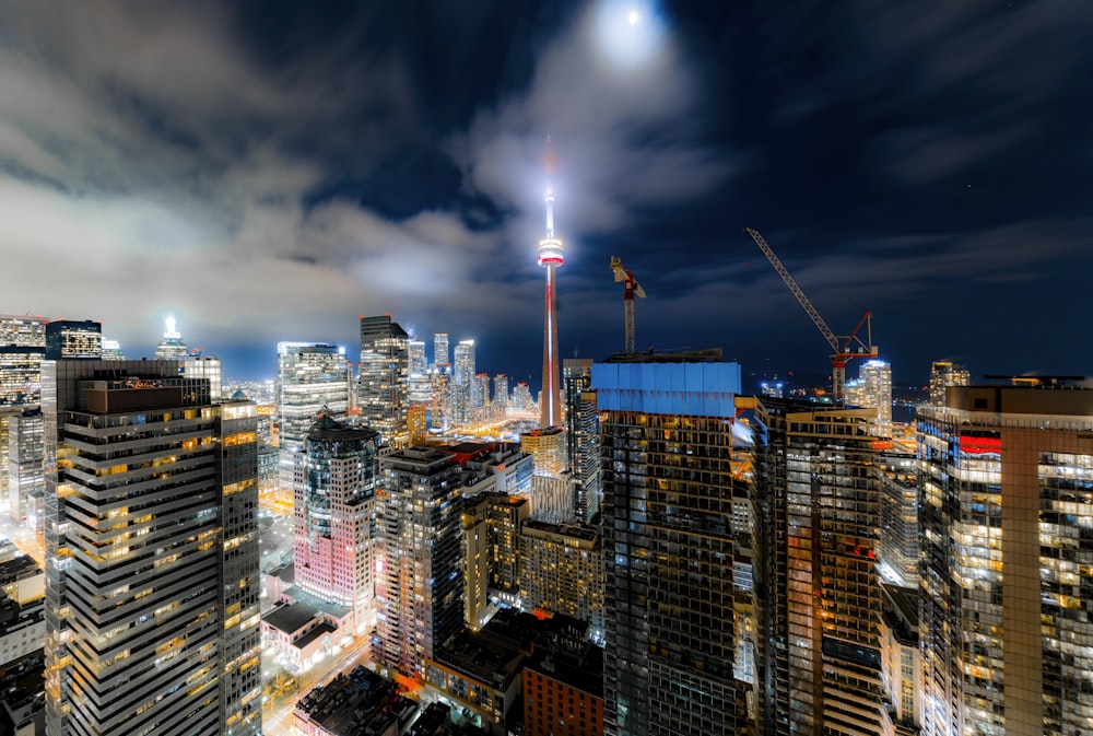 a view of a city at night from the top of a skyscraper