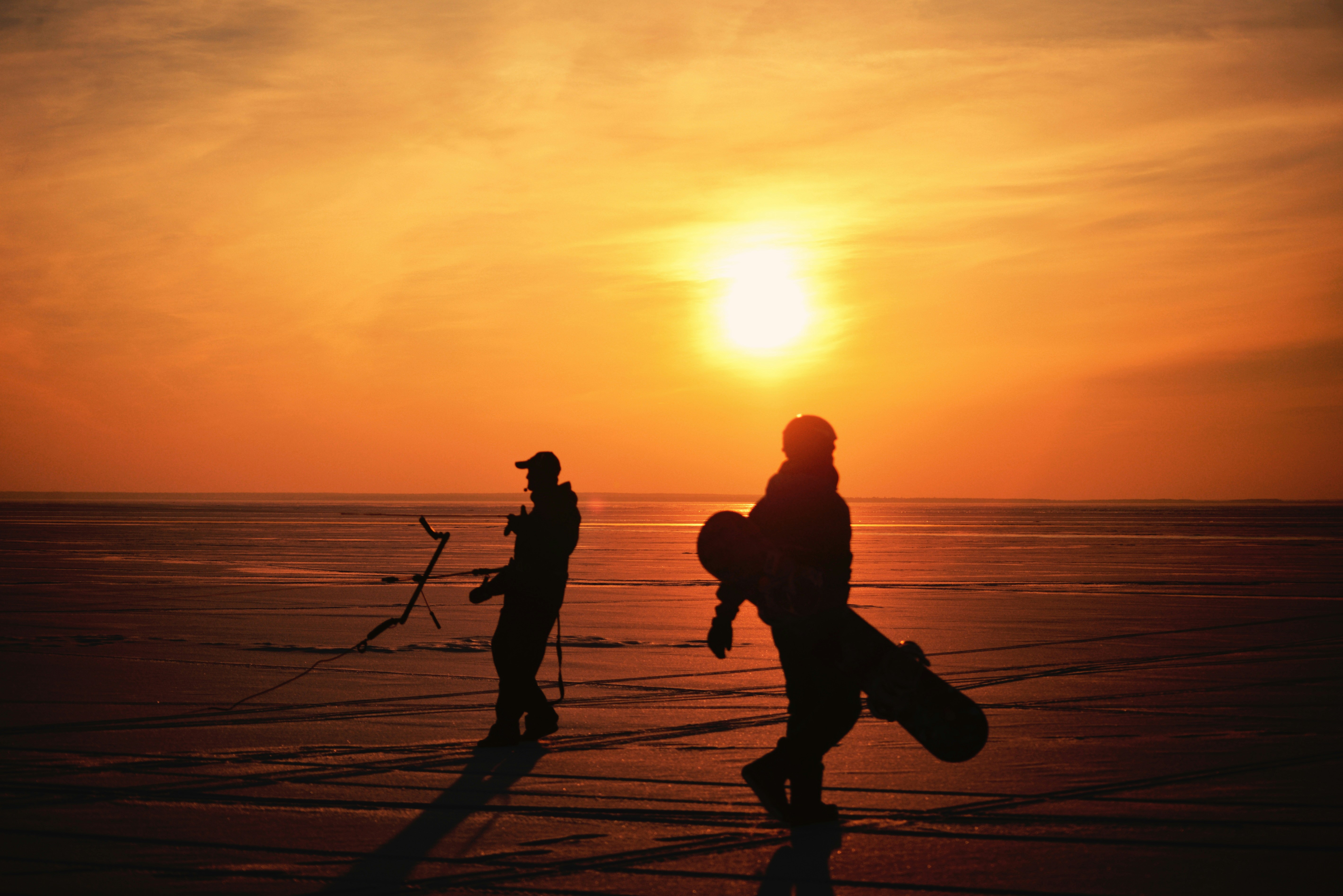 a couple of people standing on top of a beach