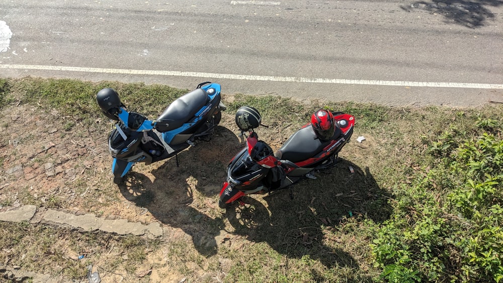 two motorcycles parked next to each other on the side of a road
