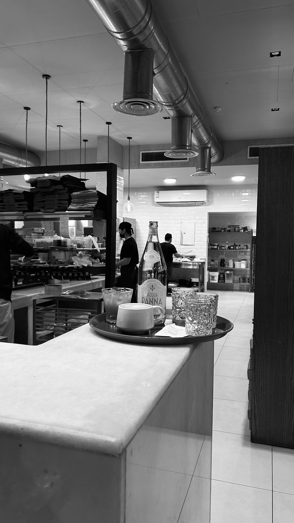 a black and white photo of a counter in a restaurant