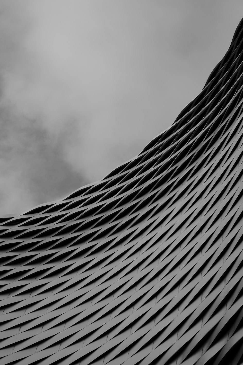 a black and white photo of a curved building