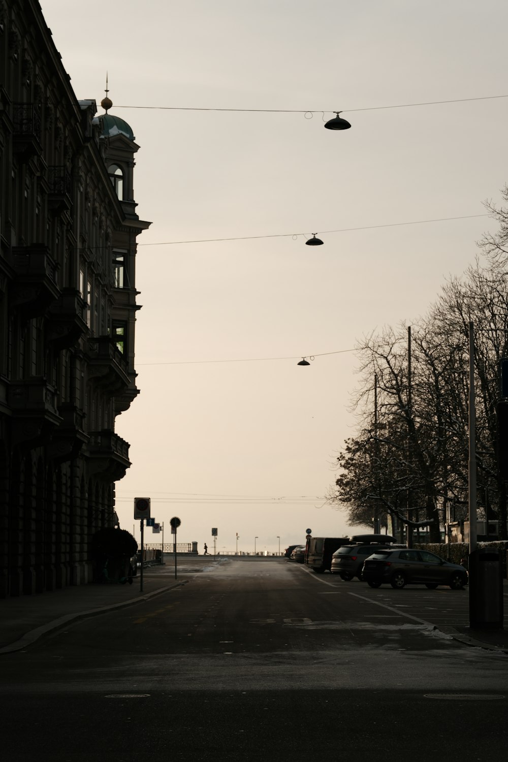 a city street with cars parked on the side of it