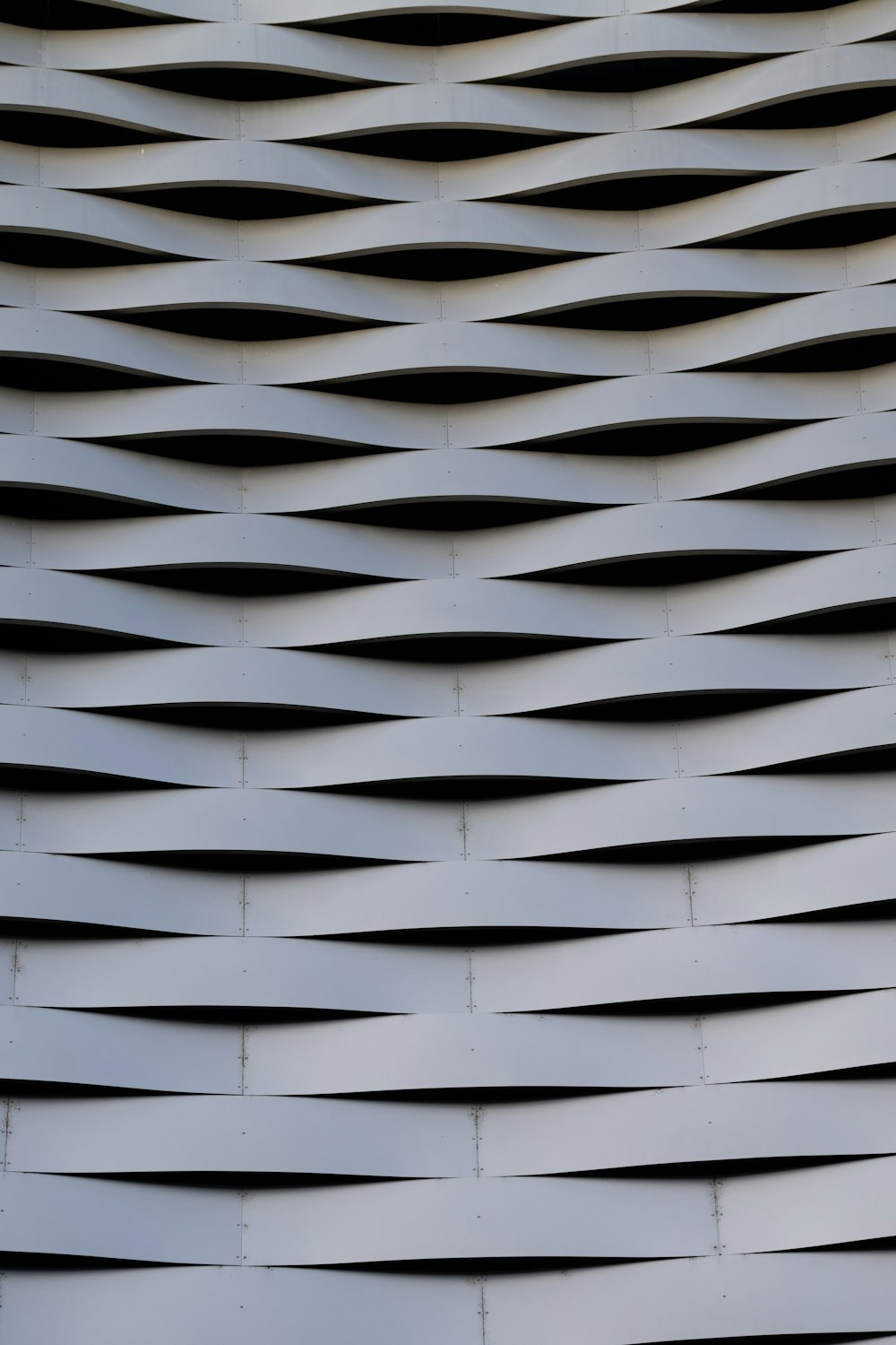 a close up of a metal structure with wavy lines