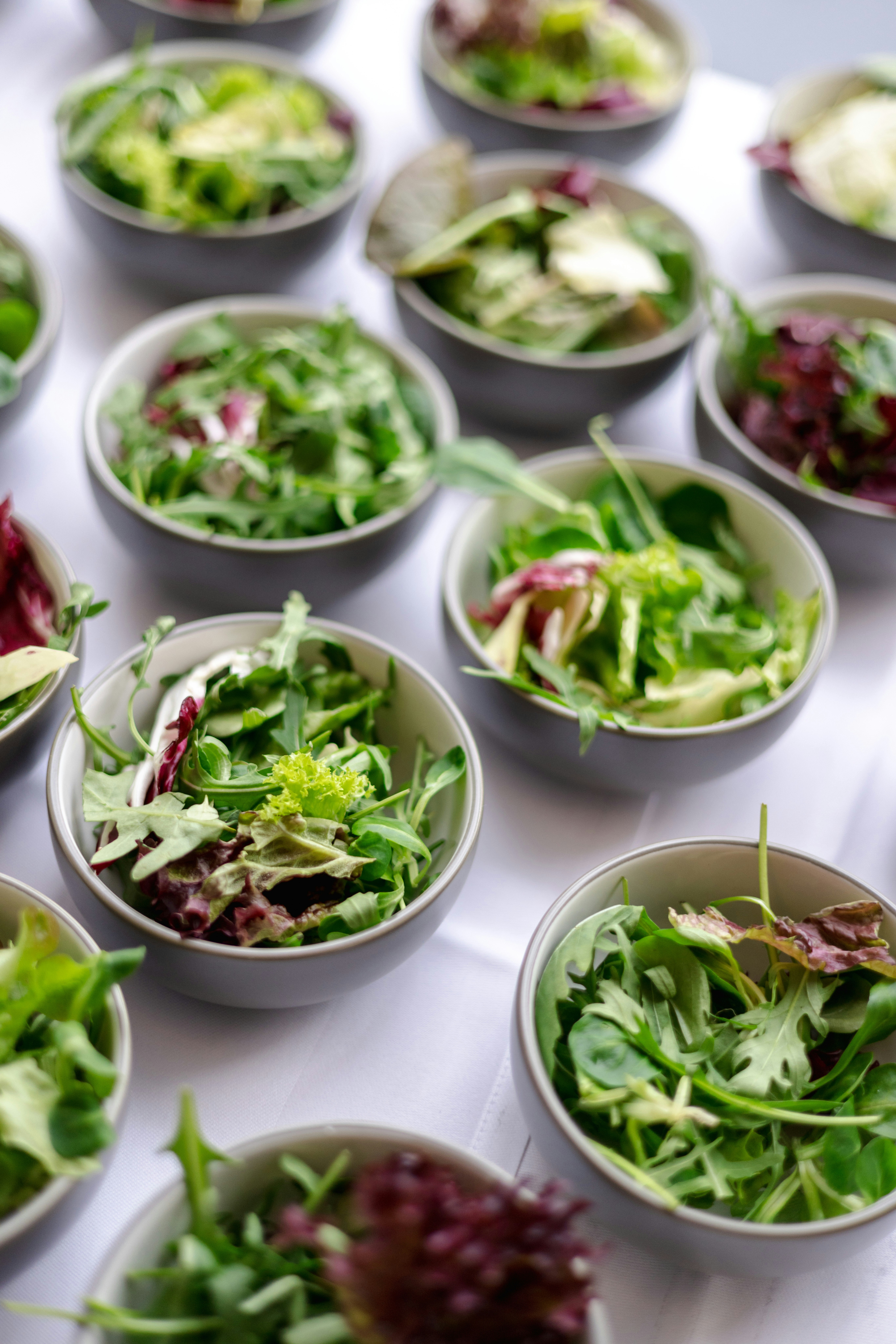 a table topped with bowls filled with different types of salads