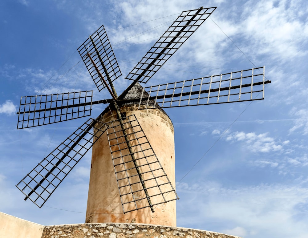 a windmill is shown against a blue sky