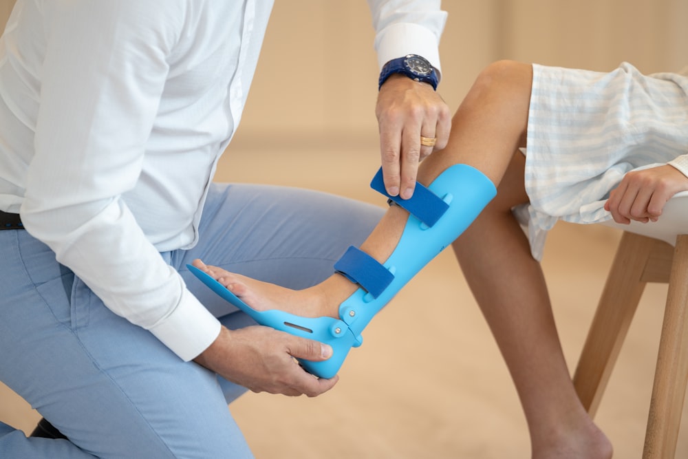 a person sitting on a chair with a foot in a cast